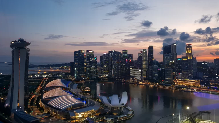 Marina Bay at dusk, with the city skyline, ArtScience Museum and the bayfront convention centre