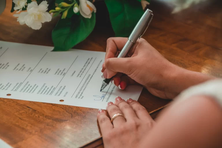 A couple signing their marriage papers at a solemnisation
